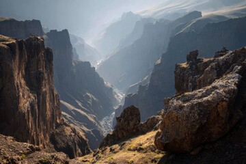 Majestic mountain landscape showcasing rugged cliffs and deep valleys during early morning light in a remote area