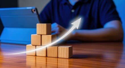 Growth Concept with Wooden Blocks and Arrow, Person Using Tablet in the Background, Investment and Career Success