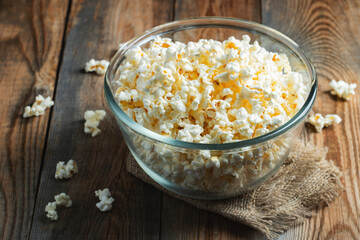Pop corn on wood color background.Food and snack concepts ideas.Minimal style top view mockup