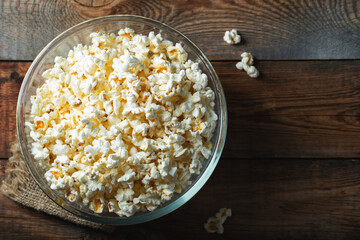 Pop corn on wood color background.Food and snack concepts ideas.Minimal style top view mockup