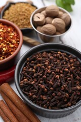 Different aromatic spices on white table, closeup