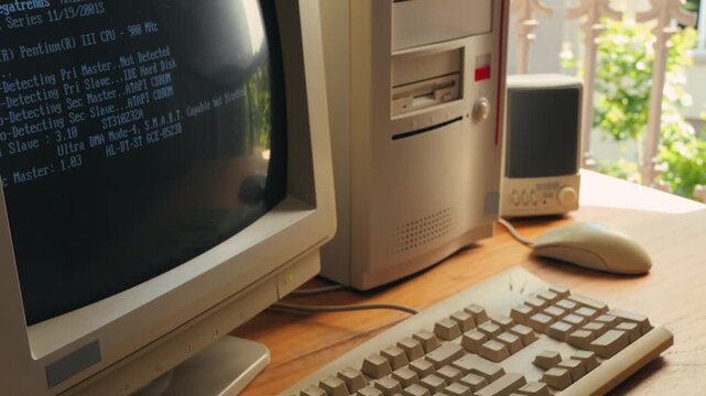 Man working and gaming on retro computer PC, IT engineer with vintage computer at home, using old fashion technology, close up of retro setup. 