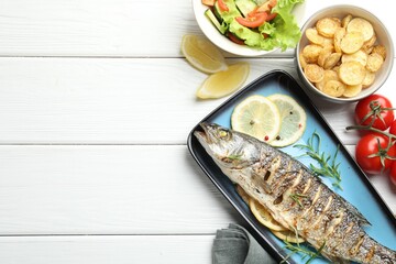 Homemade seafood dish. Tasty roasted seabass fish served with salad and potatoes on white wooden table, flat lay. Space for text