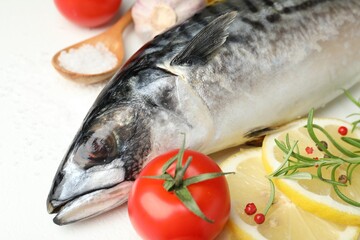 Fresh raw mackerel and spices on white table, closeup. Seafood delicacies