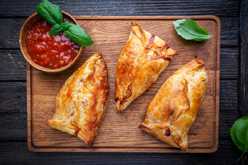 Fototapeta na wymiar Asian food Samsa or samosas with chicken fillet on cutting board. Top view