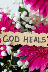 God heals, inspirational handwritten Christian quote. Close-up. Biblical concept.