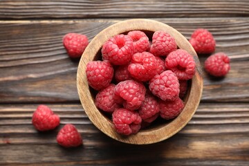 Tasty fresh ripe raspberries on wooden table, flat lay