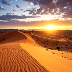 Sun setting over expansive sand dunes, creating a warm, textured landscape