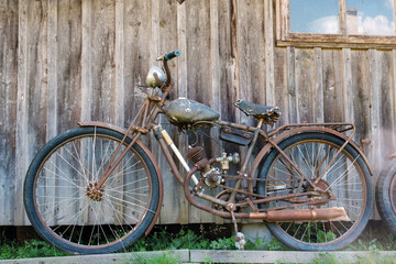 The old and rusty motorcycle on the street