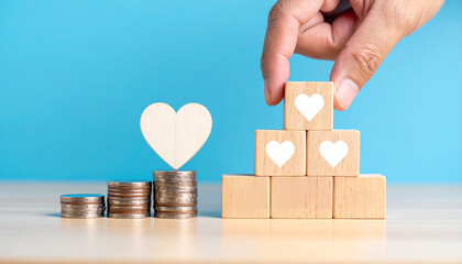 A hand building a staircase from wooden blocks with hearts