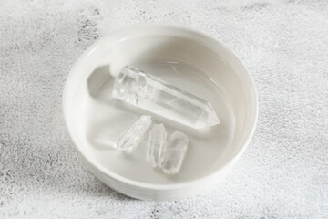 Aura. Beautiful crystals on white textured table, above view