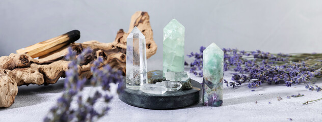Aura. Different crystals, lavender and Palo Santo stick on white textured table