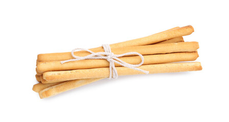 Many delicious grissini sticks isolated on white