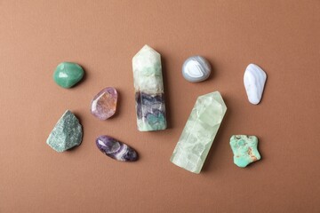 Aura. Different natural mineral stones on brown background, flat lay