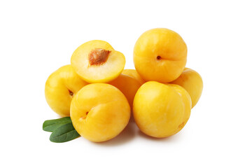 Whole and cut yellow cherry plums with leaves isolated on white