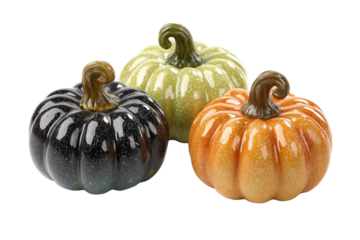 Three decorative ceramic pumpkins in black orange and green isolated on a transparent background autumn