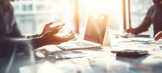 The collaborative atmosphere around a laptop during a business meeting