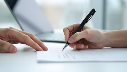 close up of hand writing on paper