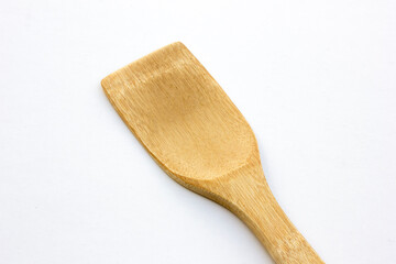 A spatula made of bamboo isolated on white background. Bamboo kitchen utensils offer several benefits, making them a popular and eco-friendly choice. They are lightweight, durable, and heat-resistant.