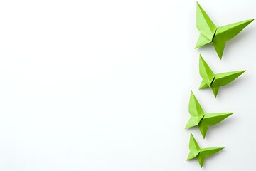 Green origami butterflies arranged in diagonal line on white background, minimalist paper art design for creative projects and decorative elements.