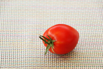 Fresh tomatoes on a black mirror background.