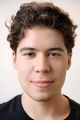 Obraz premium Young man with curly hair posing for portrait