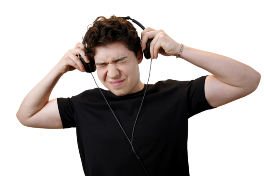 Young man suffering from loud music in headphones