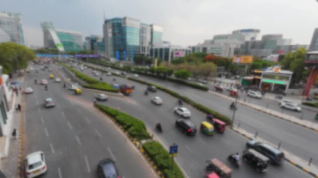 Blurred top angle view of the road traffic in Gurgaon near Cyber City metro station, India. Time lapse motion video for background.	
