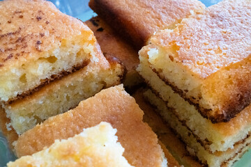 Close-up of freshly baked squares of golden cornbread, showcasing a fluffy texture and slightly crispy edges, ideal for food photography and culinary use.