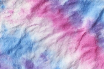 Colorful tie-dye fabric with pink and blue patterns displayed during a crafting session indoors in the afternoon sunlight