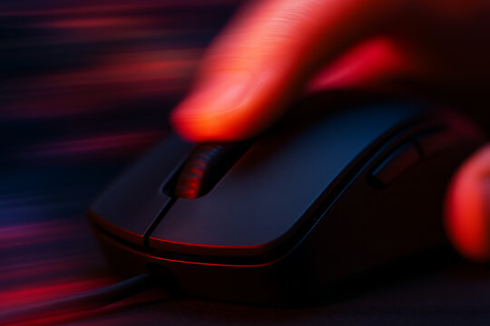Close up of hand using computer mouse with red and blue motion blur light trails, modern gaming accessory, ergonomic design, technology hardware, digital navigation, fast internet browsing, esports eq