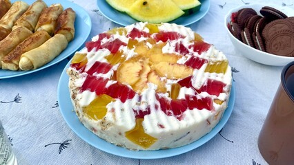 Assorted Desserts on Table: Yellow Watermelon, Fruit Cake, Pancakes and Cookies