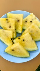 Plate of Sliced Yellow Watermelon on a Solid Background. Fresh Summer Dessert
