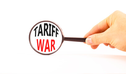 Trade tariff war symbol. Concept word Tariff war on beautiful magnifying glass. Businessman's hand....