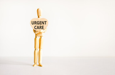 Urgent care symbol. Concept words Urgent care on beautiful wooden heart. Doctor's model. Beautiful white background. Copy space. Medical healthy lifestyle urgent care concept.