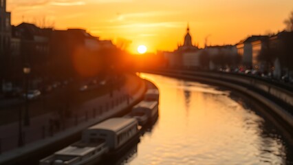 Golden sunset reflecting on a calm urban canal, creating a serene cityscape.