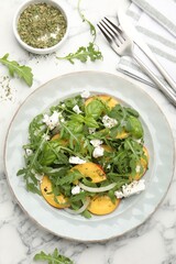 Tasty salad with arugula, cheese, peach, basil and spices on white marble table, flat lay