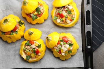 Tasty stuffed pattypan squashes on dark textured table, top view