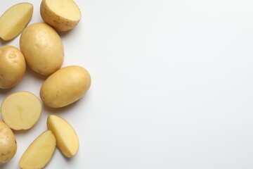 Fresh raw potatoes on light grey background, flat lay. Space for text