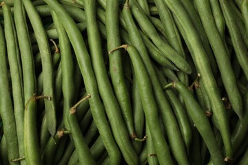 Fresh pea pods as background, top view