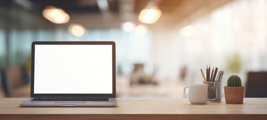 The modern workspace highlighting a laptop, cup, and decorative elements.