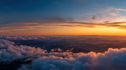 Obraz premium Breathtaking Aerial View of Mountains and Clouds at Sunset, Featuring Colorful Sky and Serene Atmosphere