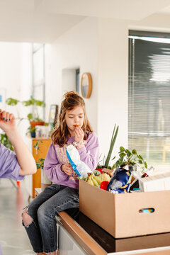 Girl enjoying snack from grocery box