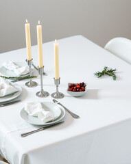 Elegant dining table set for festive celebration with candles and decor  