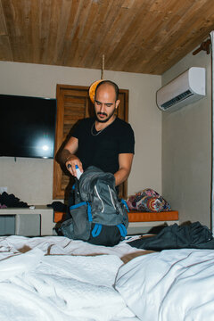 Man folding clothes neatly for trip