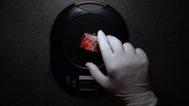 Chef places sushi on digital scale to check precise weight, symbolizing quality control, accuracy, and the discipline of professional Japanese culinary standards.