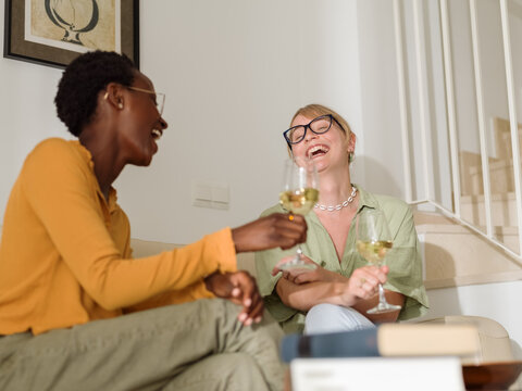 Diverse friends sincerely laughing at joke