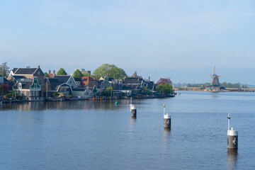 rural dutch country skyline of small old town Zaanse Schans with fog, Netherlands