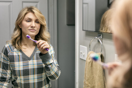 Home: Woman Brushes Teeth First Thing In Morning