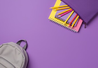 Colorful School Supplies with Notebooks and Pencils on Purple Background